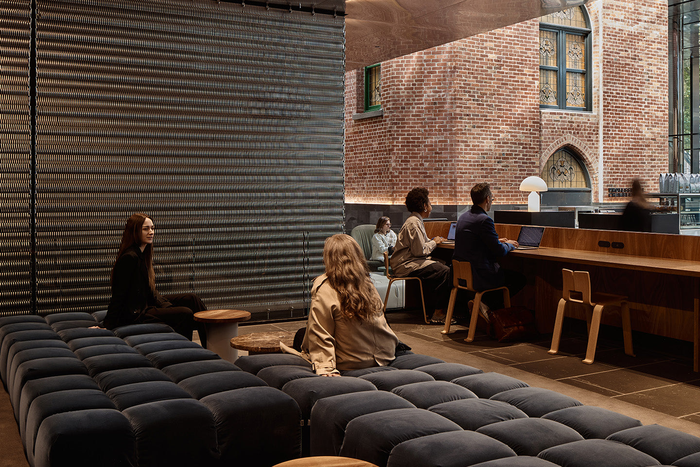 Relaxing on the mezzanine with views to the surrounding historic buildings, here B&B Italia Tufty-Time in soft grey velvet provides a place to catch up with friends and colleagues. Photography © Peter Bennetts c/o Hassell.
