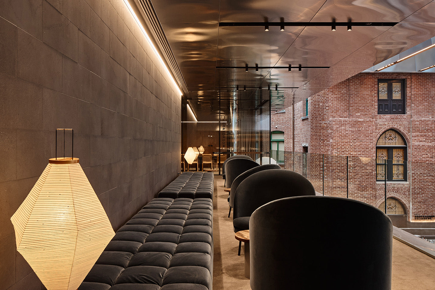 An anti-space off the boardroom with a B&B Italia Tufty-Time sofa and Jim armchairs by Arflex, offset by the textural warmth of the surrounding heritage buildings. Photography © Peter Bennetts c/o Hassell.
